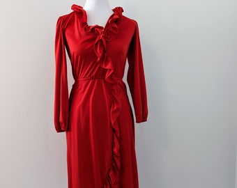 May include: A red wrap dress with a ruffled neckline and long sleeves. The dress has a fitted bodice and a flowing skirt.