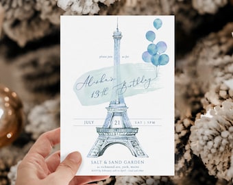 May include: A blue and white watercolor illustration of the Eiffel Tower with blue balloons. The text "Alisha's 13th Birthday" is written in a script font. The date is July 21st, 2028, and the time is 5 PM. The location is Salt & Sand Garden, 21 Richmond Ave, York, Maine. RSVP by February 1st to April 1st, (207) 436-7890.