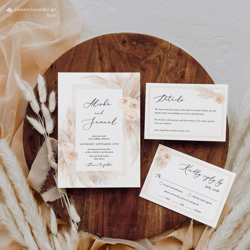 May include: Wedding invitation suite with a beige background and a watercolor design of pampas grass and flowers. The invitation card features the names "Alisha and Januel" and the date "Saturday, September 14th". The RSVP card has a beige background with a watercolor design of pampas grass and flowers. The RSVP card has a checkbox for "Accept with pleasure" and "Decline with regret". The RSVP card also has a checkbox for "Beef", "Fish", and "Chicken".