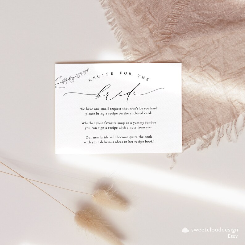 May include: A white card with black text that reads "Recipe for the Bride". The card requests guests to bring a recipe on the enclosed card for the bride's new recipe book.