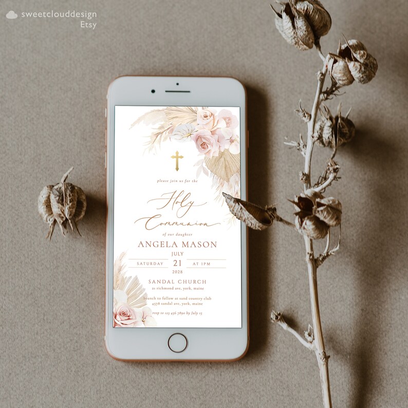 May include: A digital invitation for a Holy Communion celebration with a floral design featuring a cross, pampas grass, and roses in shades of pink and beige. The invitation includes the name Angela Mason, the date July 21, 2028, and the time 1 PM. The event will be held at Sandal Church.