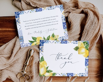 May include: Two thank you cards with a blue and white tile pattern border and lemons. The top card says "Thank you for being there for us and making it the best day of our lives. It was great to celebrate with you guys. We look forward to starting this next chapter of our lives together and sharing many more memories with you all. Love, Melody + Jabutica."