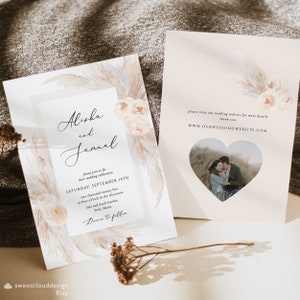 May include: Wedding invitation with a watercolor design featuring pampas grass and flowers in shades of beige and peach. The invitation includes the names "Alisha and Jamal" and details for their wedding ceremony on September 14th, 2025 at Salt and Sand Garden in York, Maine. The invitation also includes a website address for more information: WWW.OURWEDDINGWEBSITE.COM.