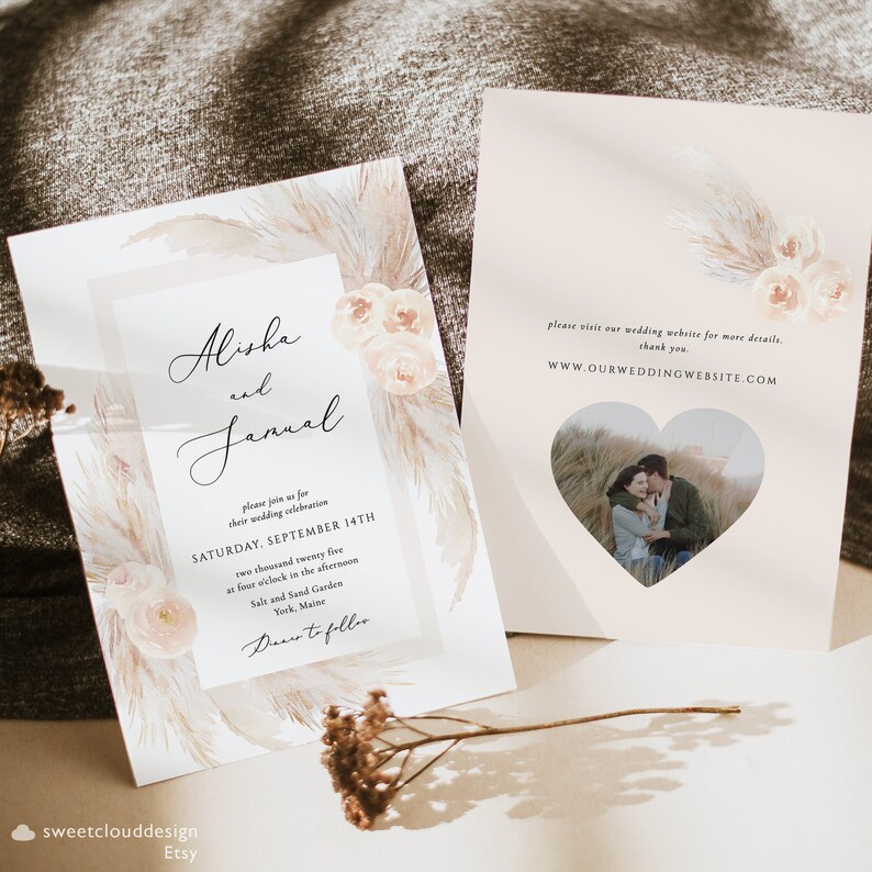 May include: Wedding invitation with a watercolor design featuring pampas grass and flowers in shades of beige and peach. The invitation includes the names "Alisha and Jamal" and details for their wedding ceremony on September 14th, 2025 at Salt and Sand Garden in York, Maine. The invitation also includes a website address for more information: WWW.OURWEDDINGWEBSITE.COM.