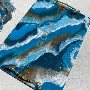 May include: A rectangular serving tray with a blue, white, and gold abstract design. The tray has two gold handles shaped like branches. The word "GOLD" is written in white on the tray.