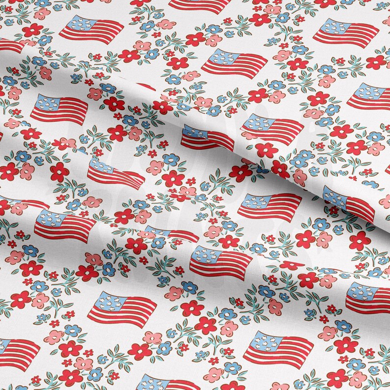 May include: White fabric with a repeating pattern of red, white, and blue American flags surrounded by small red, blue, and green flowers.