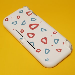 May include: White Nintendo Switch case with a pattern of red and blue triangles. The case has a cutout for the console's kickstand.