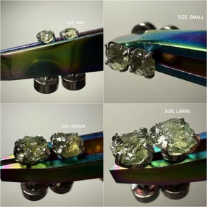 May include: Four pairs of raw, pale green gemstone stud earrings held by iridescent tweezers. The sets are labeled by size as MINI, SMALL, MEDIUM, and LARGE. Each earring features a rough, textured stone set in a metal prong setting with a post back.