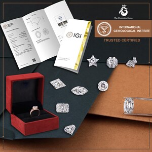 May include: A collection of loose faceted diamonds in various shapes including star, rabbit, round, and geometric cuts, alongside a diamond ring in a red velvet box and an International Gemological Institute laboratory report document.