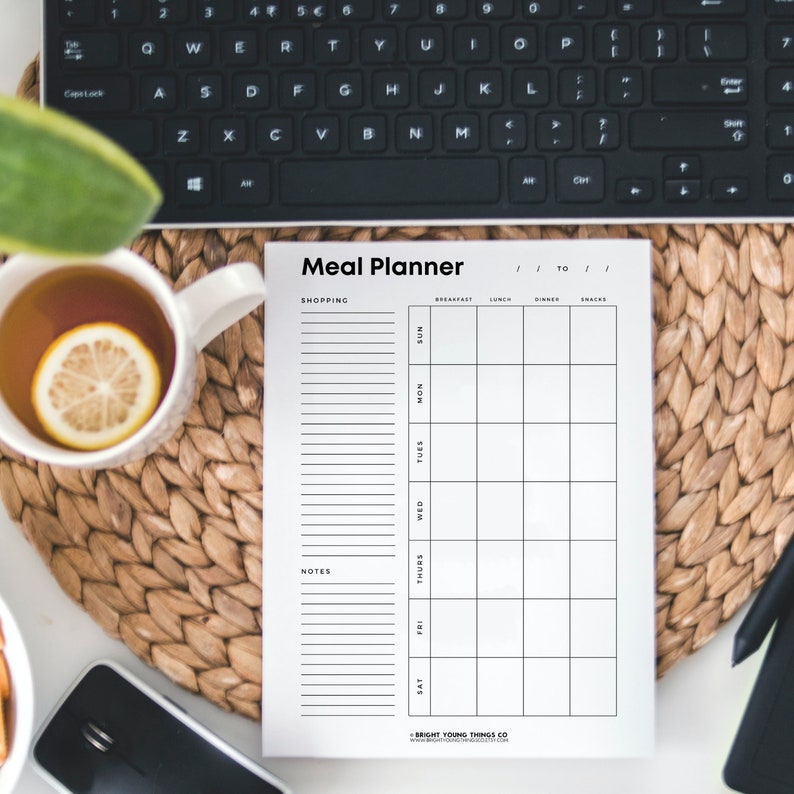 May include: A black and white printable meal planner with sections for shopping, notes, and daily meals from Saturday to Sunday. The planner includes columns for breakfast, lunch, dinner, and snacks.