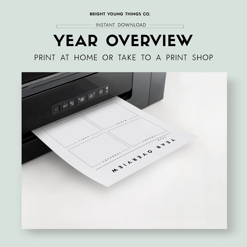 May include: A black and white printable year overview planner with six sections for each month of the year. The planner is being printed from a black printer.
