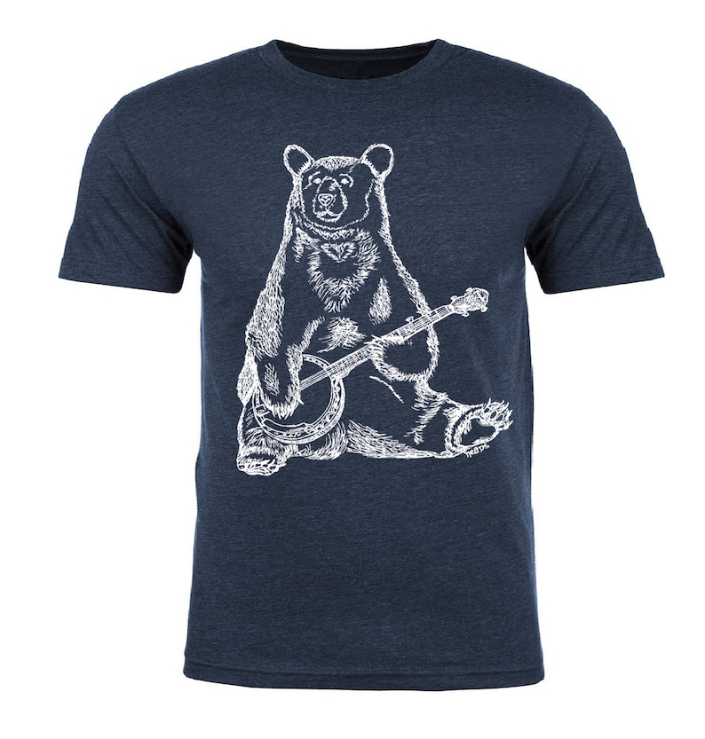 May include: A navy blue t-shirt with a white illustration of a bear playing a banjo.