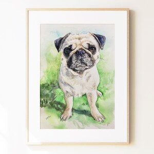 May include: A framed watercolor painting of a fawn-colored pug with a black muzzle and dark ears. The dog is standing against a soft, blended green and blue background. The artwork is enclosed in a simple, light-colored wooden frame with a white mat.