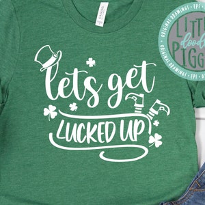 May include: Green t-shirt with white text that says "let's get lucked up!"  A green shamrock and a leprechaun's hat are also on the shirt.