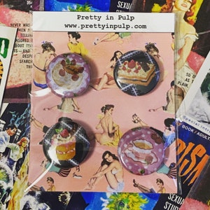 May include: Four round pinback buttons with dessert designs, packaged on a pink background with vintage illustrations. The buttons feature images of cakes and pastries. The packaging includes the text "Pretty in Pulp" and the website address.