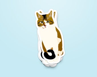 May include: A sticker featuring a cartoon illustration of a brown, white and black cat sitting with its tail curled around its legs. The cat has green eyes and a white patch on its chest.