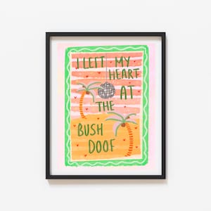 May include: Framed art print with a black border. The artwork features a colourful illustration with the text "I LEFT MY HEART AT THE BUSH DOOF". The design includes palm trees, a disco ball, and a striped background.