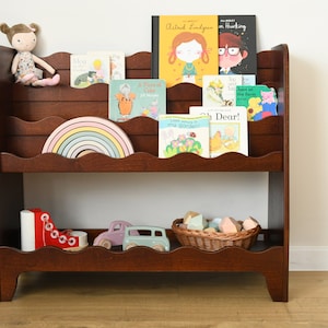 a front facing, Montessori bookcase for children, in dark brown stain