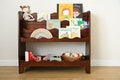 a front facing, Montessori bookcase for children, in dark brown stain