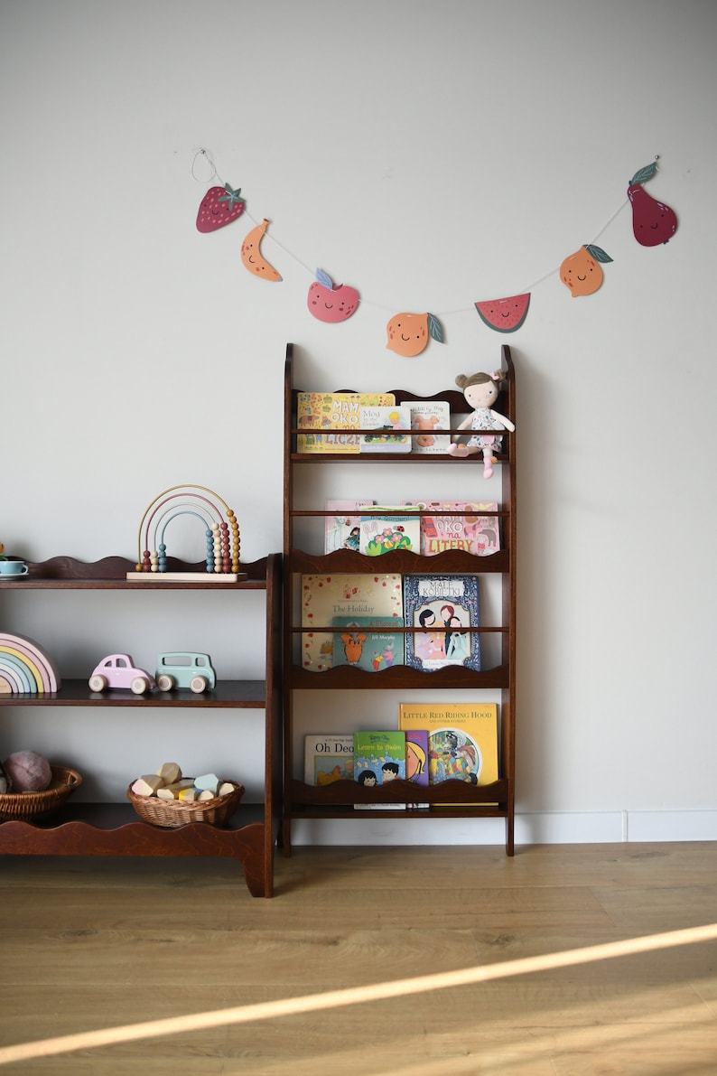 a wall mounted bookcase in dark brown stain with a wavy decor
