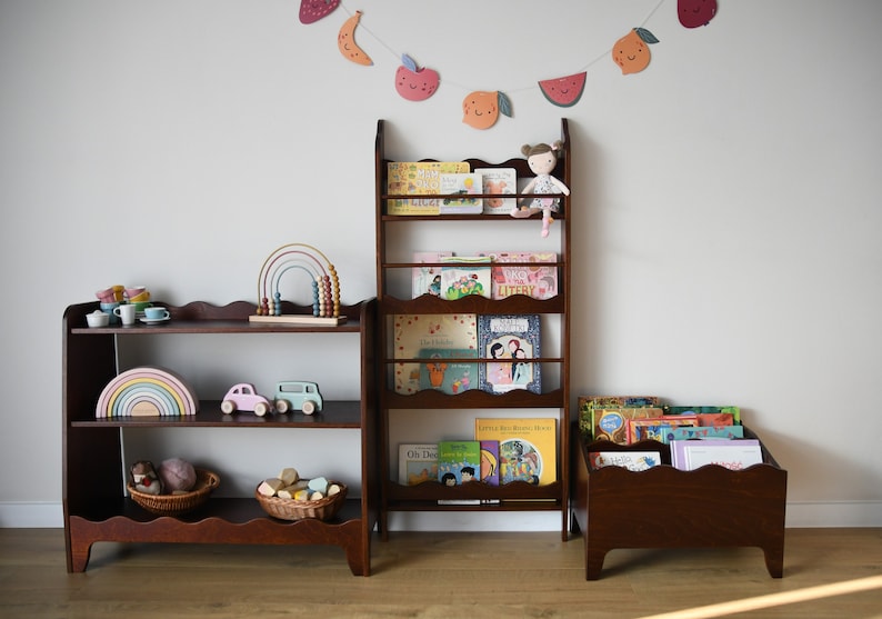 a wall mounted bookcase in dark brown stain with a wavy decor