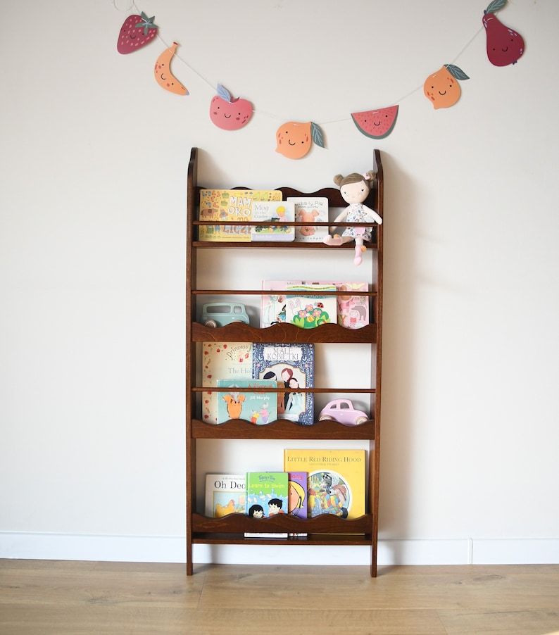 a wall mounted bookcase in dark brown stain with a wavy decor