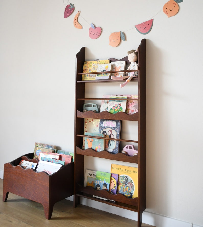 a wall mounted bookcase in dark brown stain with a wavy decor