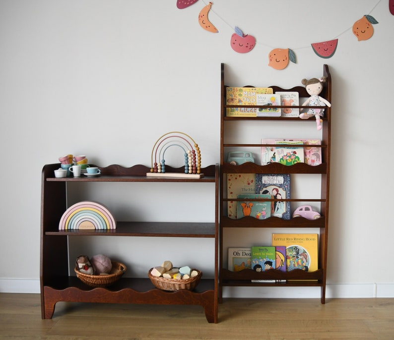 a wall mounted bookcase in dark brown stain with a wavy decor