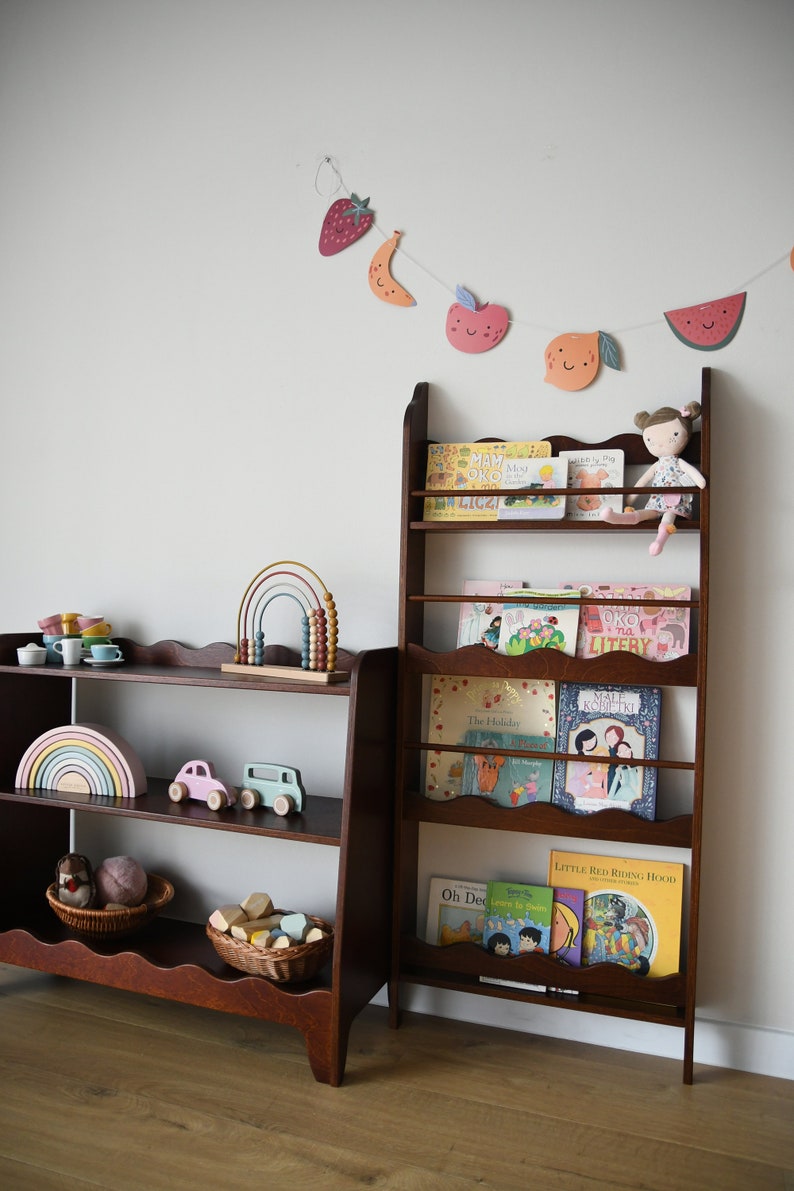 a wall mounted bookcase in dark brown stain with a wavy decor