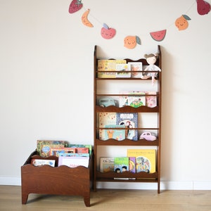 a wall mounted bookcase in dark brown stain with a wavy decor