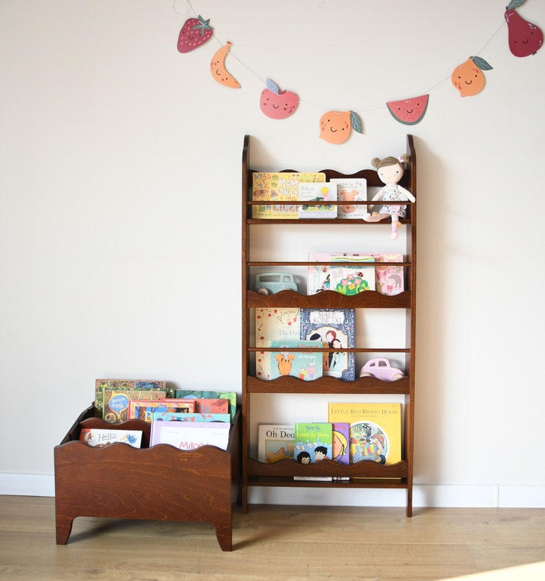 a wall mounted bookcase in dark brown stain with a wavy decor