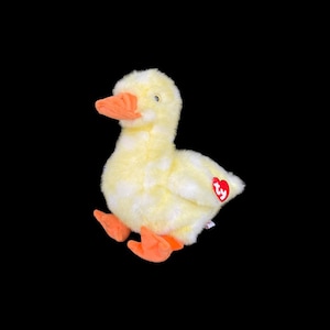 May include: A yellow plush duck with orange feet and a red Ty heart tag.