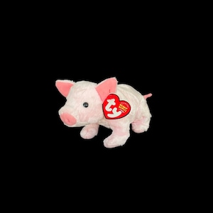 May include: Pink plush pig with a red Ty Beanie Babies tag. The tag has the words "Ty" and "Beanie Babies" on it.