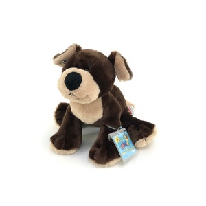 May include: Brown and tan plush dog toy with a blue tag that says "Webkinz Signature".