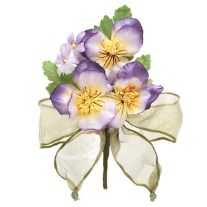 May include: A bouquet of purple and yellow artificial flowers with green leaves, tied with a sheer light green ribbon.