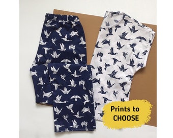 May include: Two pairs of pyjamas with a white origami bird print on a navy blue and white background. The text "Prints to CHOOSE" is visible in the image.