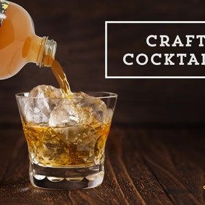 May include: A clear glass bottle with a yellow label that says "Shivelight" is pouring a golden liquid into a glass with ice. The text "CRAFT COCKTAILS" is in a white rectangle on a brown background.