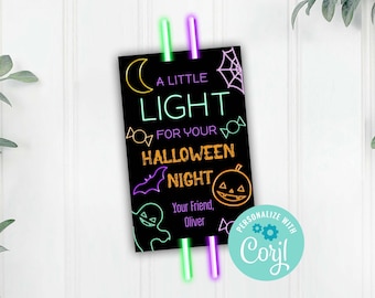 May include: A black card with a neon green and purple glow stick attached to it. The card says "A Little Light For Your Halloween Night" with a crescent moon, bat, candy, and pumpkin. The text "Your Friend, Oliver" is at the bottom of the card. The card also has a logo that says "Personalize with Coyl".