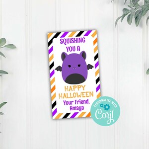May include: A purple bat with black wings and a happy face on a white card with black and orange stripes. The card says "Squishiing you a Happy Halloween. Your Friend. Amaya."