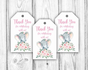 May include: Three white gift tags with a pink and green floral design and a grey elephant illustration. The text on the tags reads "Thank You for celebrating with us!"