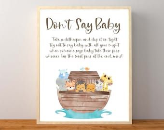May include: A printable sign for a baby shower game called "Don't Say Baby". The sign features a watercolor illustration of a brown ark with various animals inside, including a giraffe, lion, zebra, and elephant. The text on the sign reads: "Take a clothespin and clip it on tight, try not to say baby with all your might, when someone says baby take their pins, whoever has the most pins at the end, wins!"