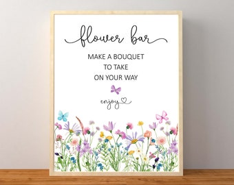 May include: A printable sign for a flower bar with the text "flower bar" in cursive script. The sign also includes the text "Make a bouquet to take on your way" and "enjoy". The sign is decorated with a border of watercolor flowers and butterflies.