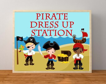 May include: A printable sign with the text "Pirate Dress Up Station" in red letters. The sign features three cartoon pirates, a treasure chest, and a pirate ship.