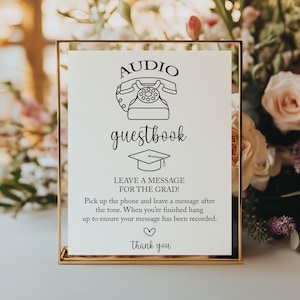 Puede incluir: Un letrero con marco dorado con las palabras "AUDIO guestbook" e instrucciones para dejar un mensaje. El letrero incluye un dibujo de un teléfono antiguo y un birrete. El texto dice "¡DEJA UN MENSAJE PARA EL GRADUADO!" y "Gracias."
