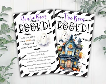 May include: Two printable Halloween "You've Been Booed!" signs with black and white striped backgrounds. One sign features a ghost and the other features a cartoon haunted house with pumpkins. The signs include instructions for a Halloween "Boo" game.