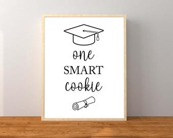 May include: A black and white printable sign with a graduation cap, diploma, and the text "one SMART cookie".