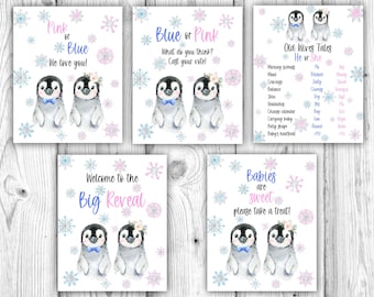 May include: Four printable signs featuring cartoon penguins with snowflakes. The signs say "Pink or Blue We love you!" "Blue or Pink What do you think? Cast your vote!" "Old Wives Tales He or She" and "Babies are sweet please take a treat!"