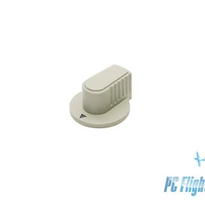 May include: A white plastic knob with a round base and a raised, oval-shaped top. The knob has a series of vertical lines on the top.