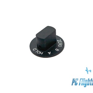May include: Black control knob with a rectangular top and a circular base. The base has the text "ZERO", "B", "A", and "HOLD" in white. The knob is likely for a flight simulator or similar device.