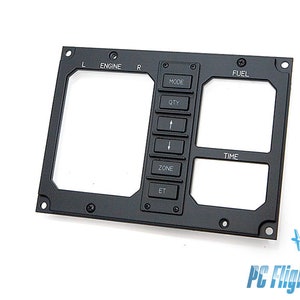 Puede incluir: Panel de metal negro con recortes para indicadores y botones. El panel tiene etiquetas para "Engine", "Mode", "Fuel" y "Time". La sección "Mode" tiene botones etiquetados "QTY", "Zone" y "ET".